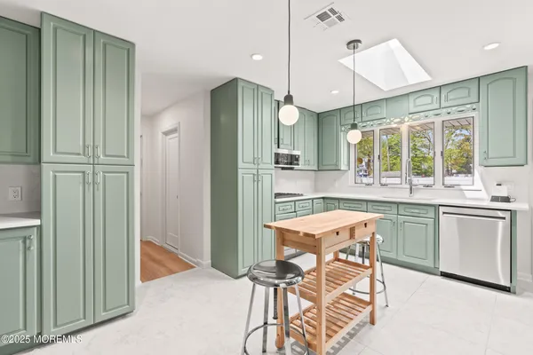 a bedroom with a sink and a mirror