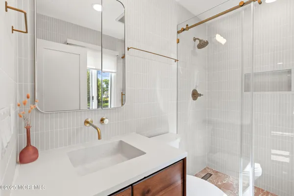 a front view of a house with a garden and yard