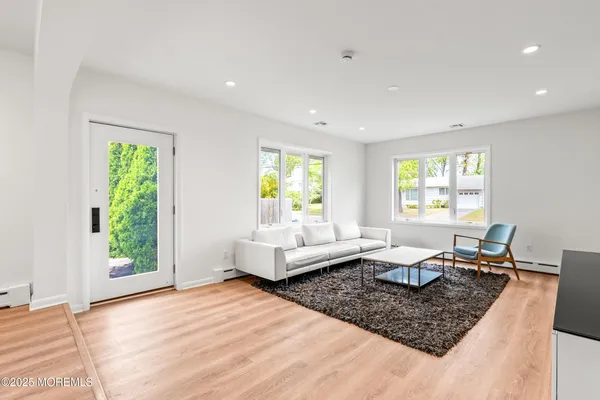 a view of a dining room with furniture and a large window