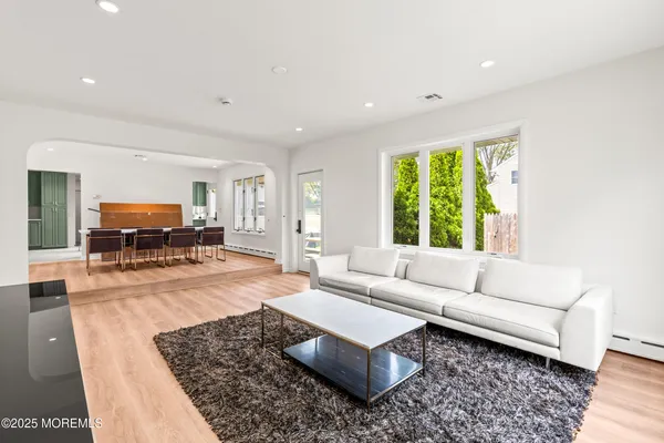 a view of a dining hall with furniture and wooden floor