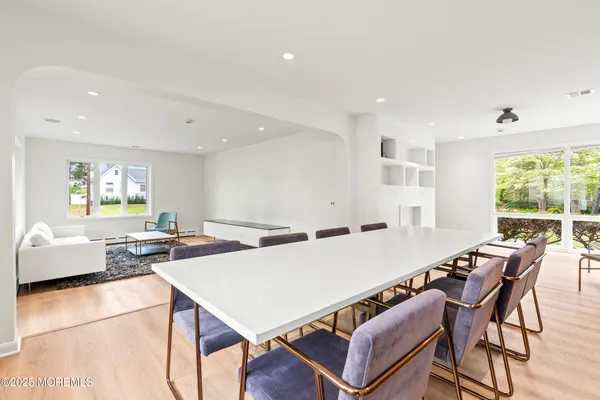a dining room with furniture and wooden floor