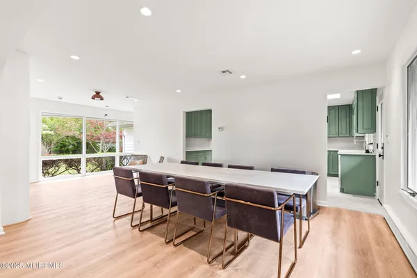 a kitchen with a table chairs sink refrigerator and microwave
