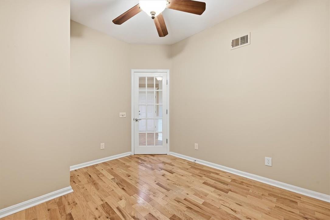 8761 Cascade Road Breinigsville, PA 18031 - Photo 27 of 84 A well-lit room features hardwood flooring and a functional ceiling fan, offering a comfortable atmosphere.
