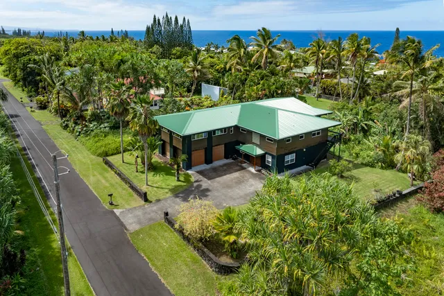 an aerial view of a house with a yard