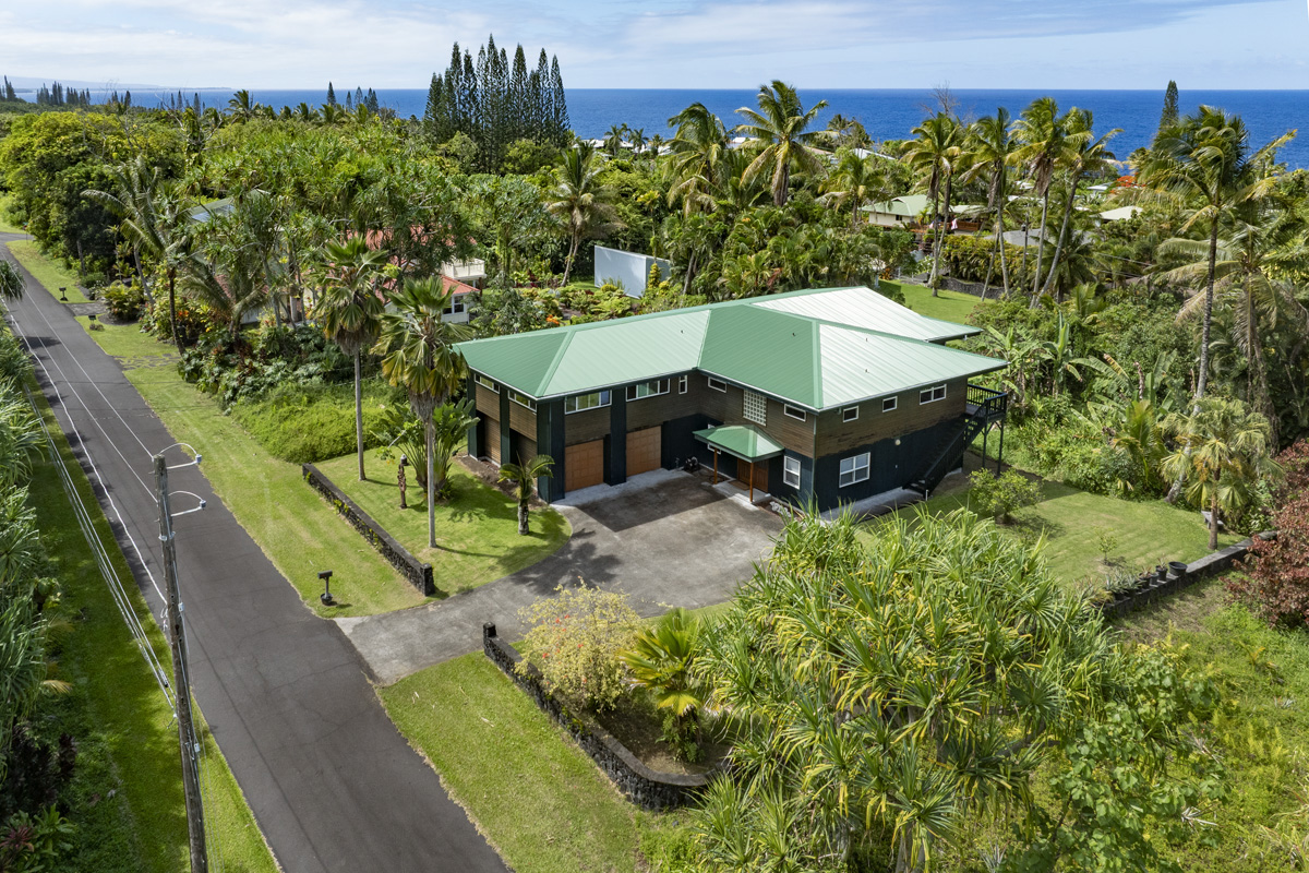 an aerial view of a house with a yard