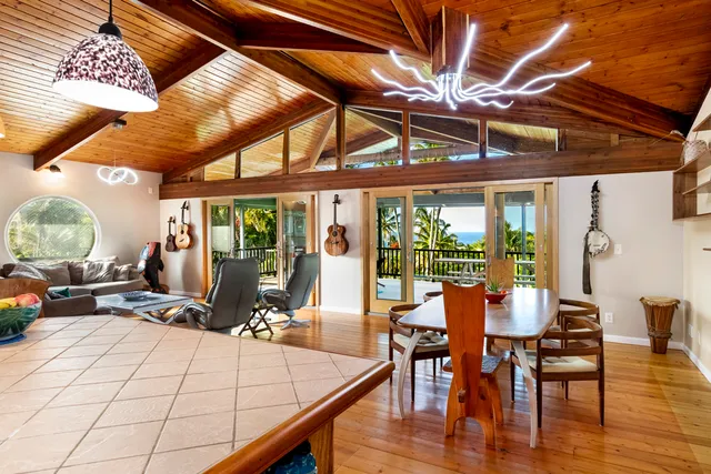 a dining room with wooden floor table and chairs