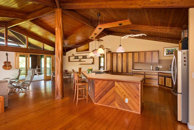 a kitchen with stainless steel appliances granite countertop a sink window and cabinets