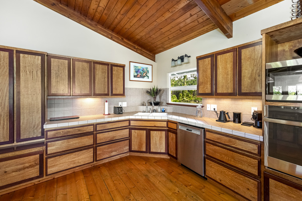 15-2817 Papai Street Pahoa, HI 96778 - Photo 15 of 30 a kitchen with stainless steel appliances granite countertop a sink window and cabinets