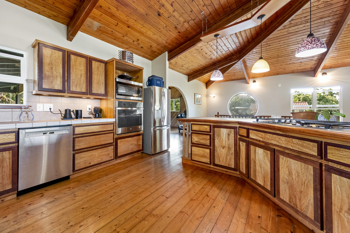 15-2817 Papai Street Pahoa, HI 96778 - Photo 16 of 30 a kitchen with stainless steel appliances granite countertop a stove a sink and a refrigerator