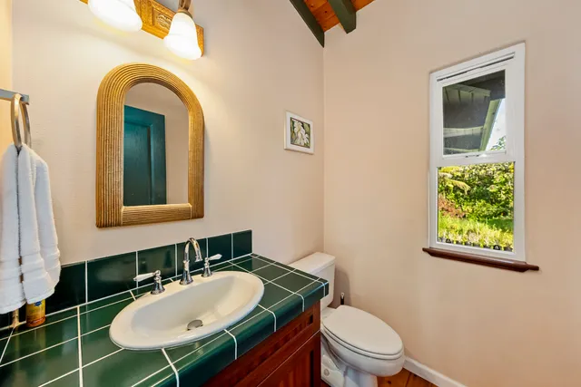 a bathroom with a sink a mirror and a vanity