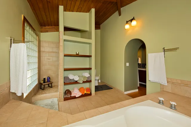 a bath tub sitting in a bathroom next to a window