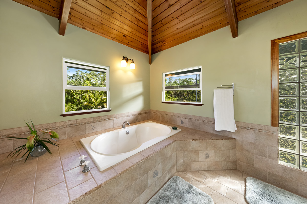 15-2817 Papai Street Pahoa, HI 96778 - Photo 22 of 30 a bath tub sitting in a bathroom next to a window