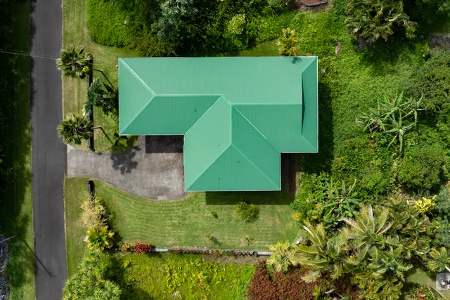 an aerial view of a house with a yard