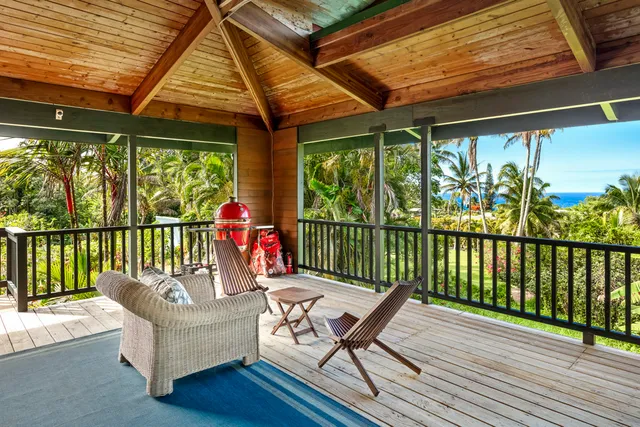 a outdoor space with the couches and dining table with wooden floor