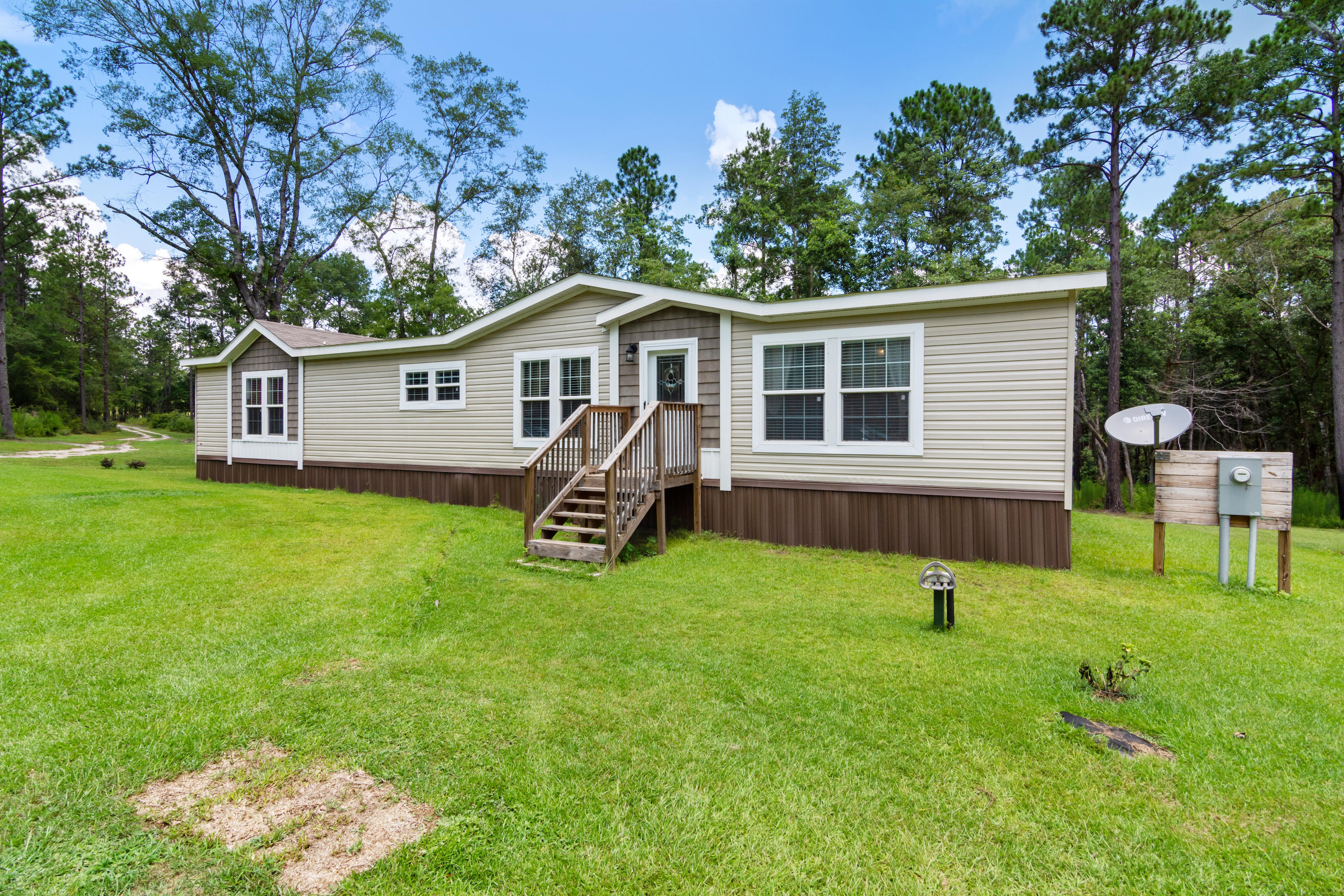 2185 Curtis Madden Road Baker, FL 32531 - Photo 2 of 41 a house that has a tree in front of it