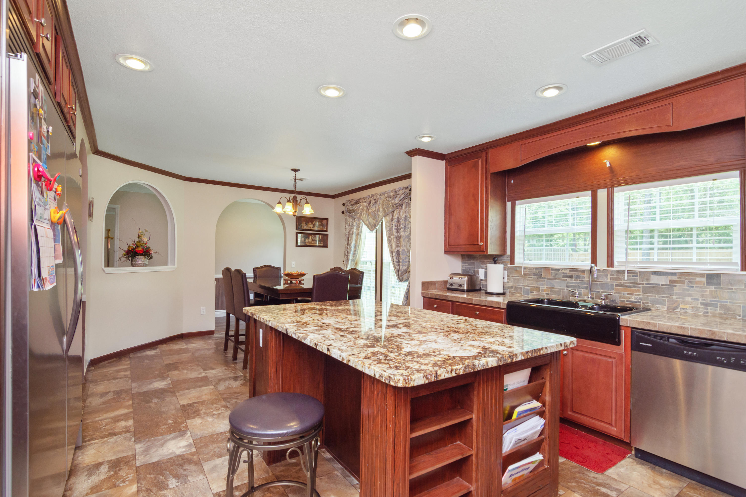 2185 Curtis Madden Road Baker, FL 32531 - Photo 11 of 41 a kitchen with granite countertop sink stove and living room