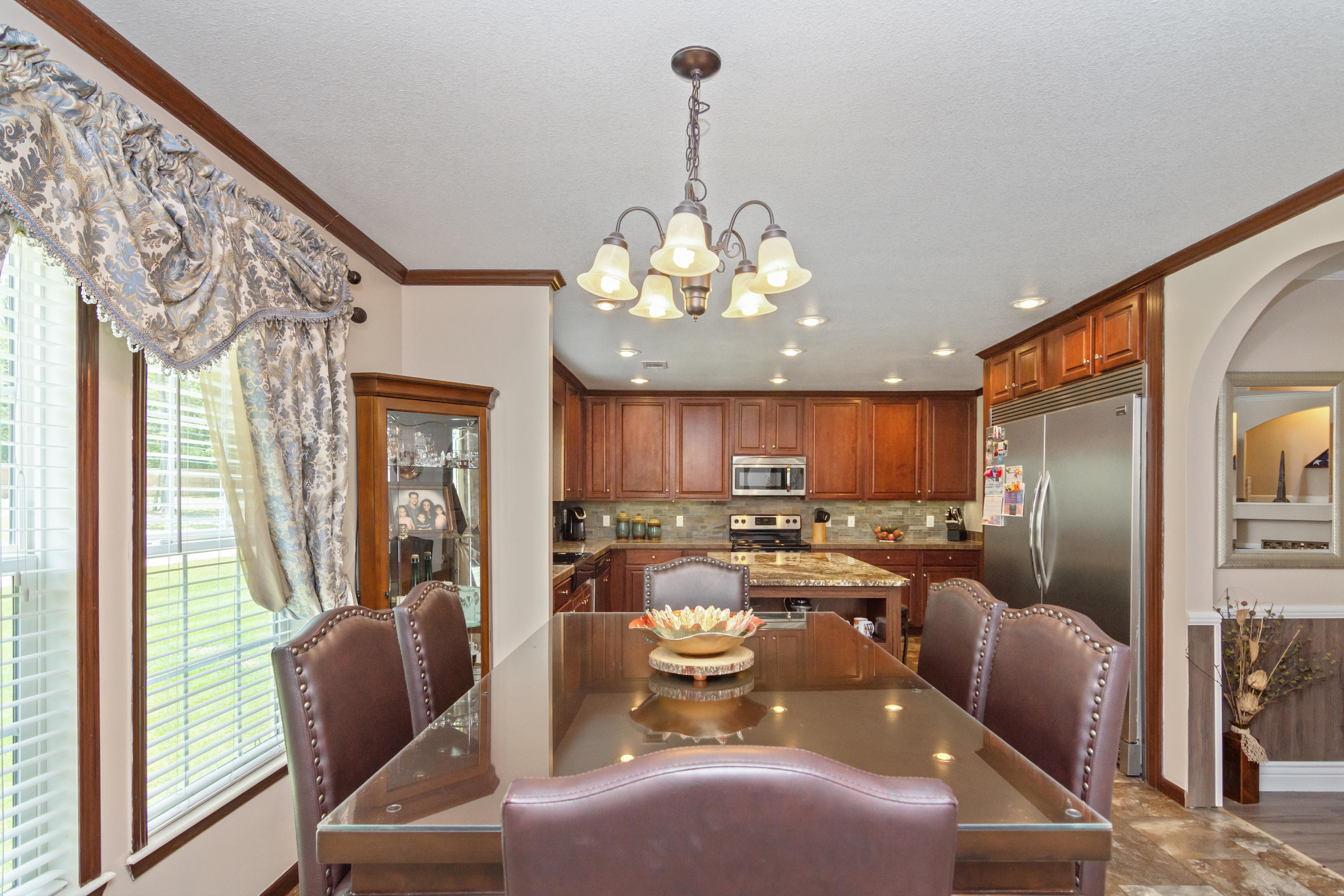 2185 Curtis Madden Road Baker, FL 32531 - Photo 14 of 41 a view of a dining room with furniture a chandelier and wooden floor