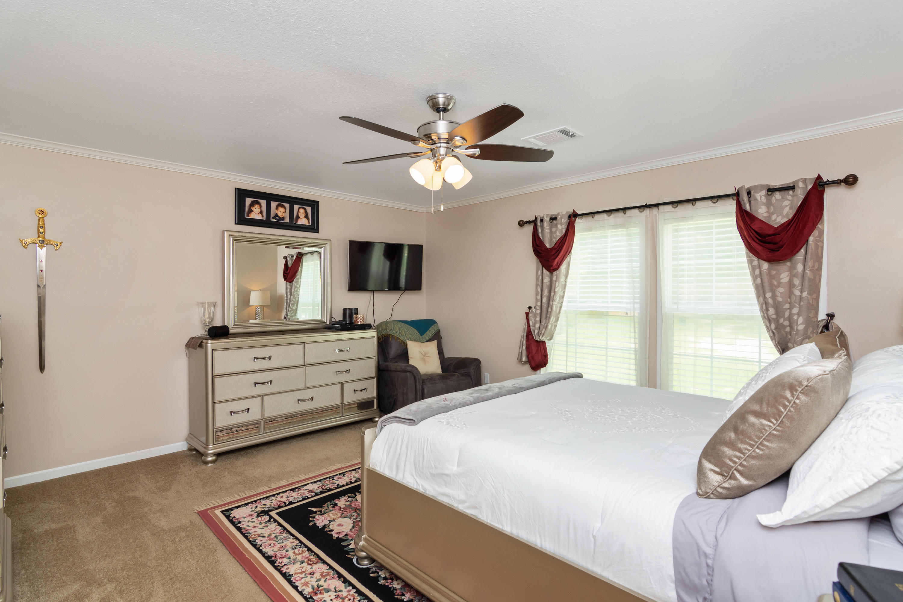 2185 Curtis Madden Road Baker, FL 32531 - Photo 16 of 41 a bedroom with a bed dresser and a window