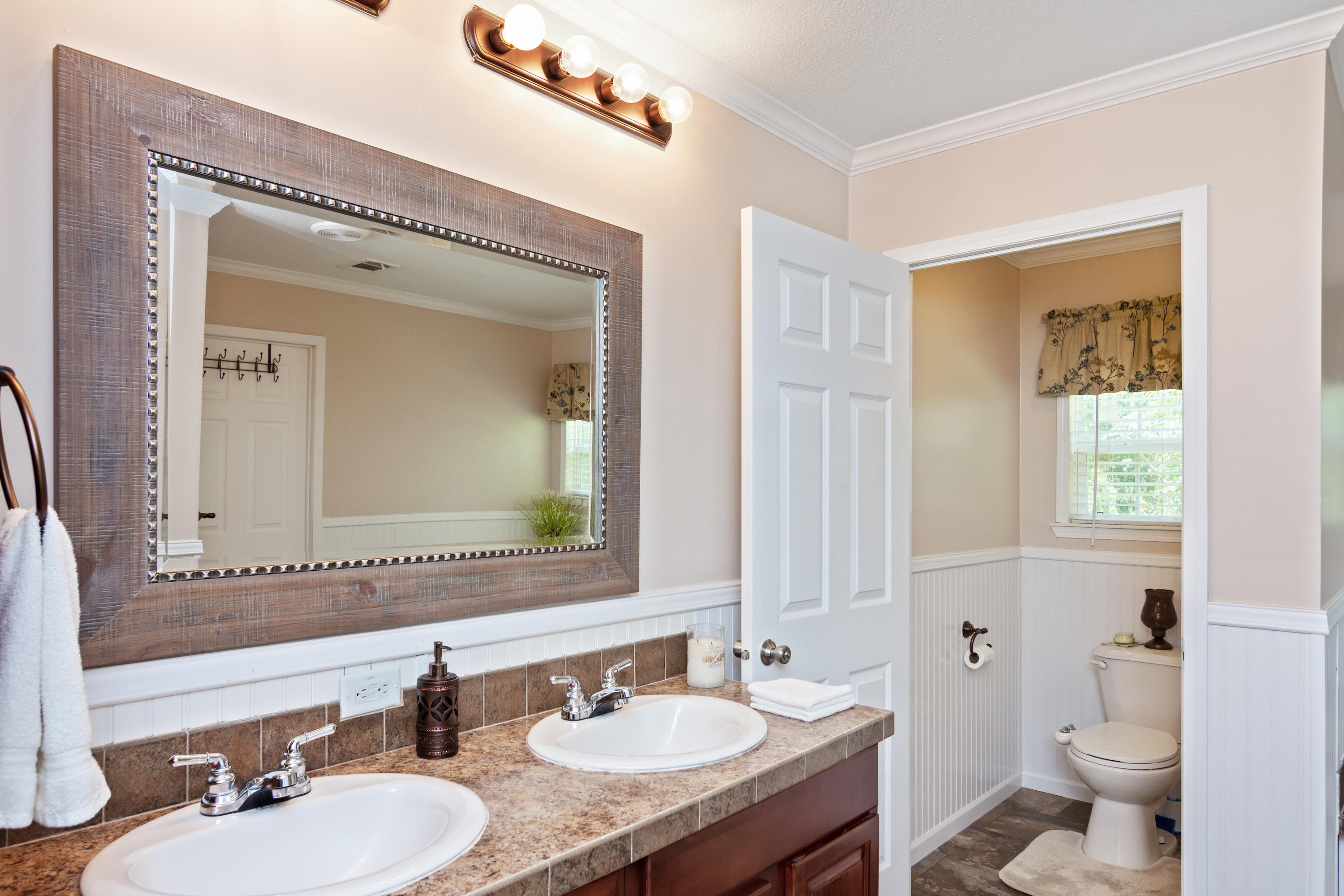 2185 Curtis Madden Road Baker, FL 32531 - Photo 18 of 41 a bathroom with a granite countertop sink mirror and a toilet