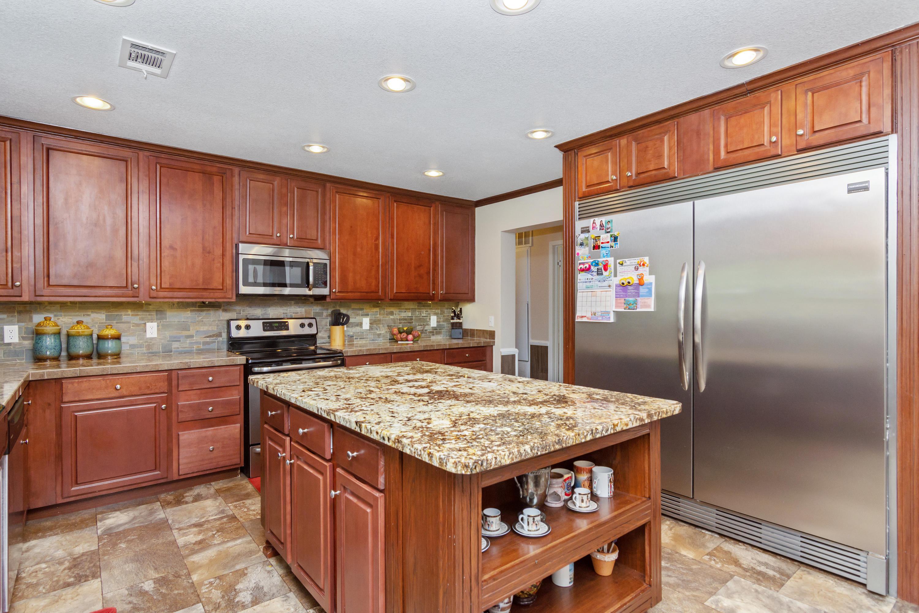 2185 Curtis Madden Road Baker, FL 32531 - Photo 8 of 41 a kitchen with stainless steel appliances granite countertop a refrigerator a sink and a microwave