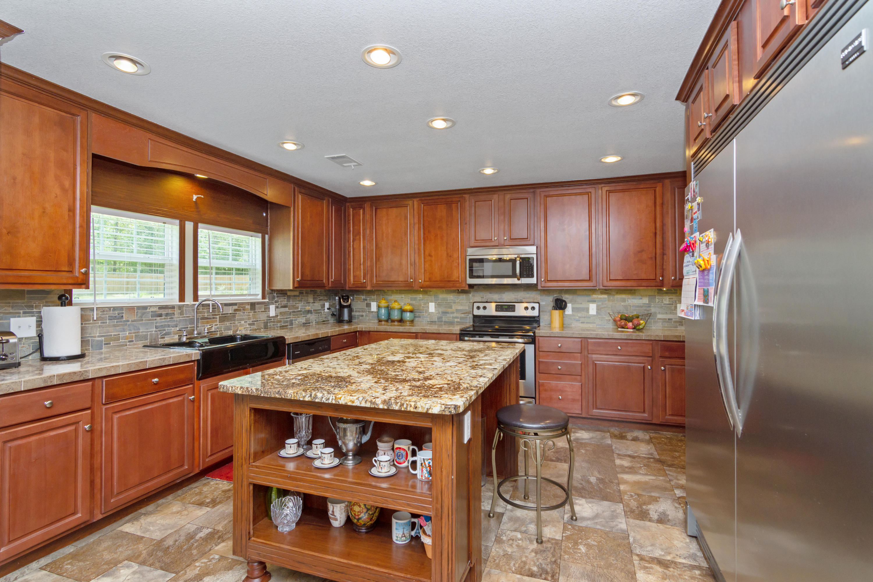 2185 Curtis Madden Road Baker, FL 32531 - Photo 9 of 41 a kitchen with stainless steel appliances granite countertop sink stove and refrigerator