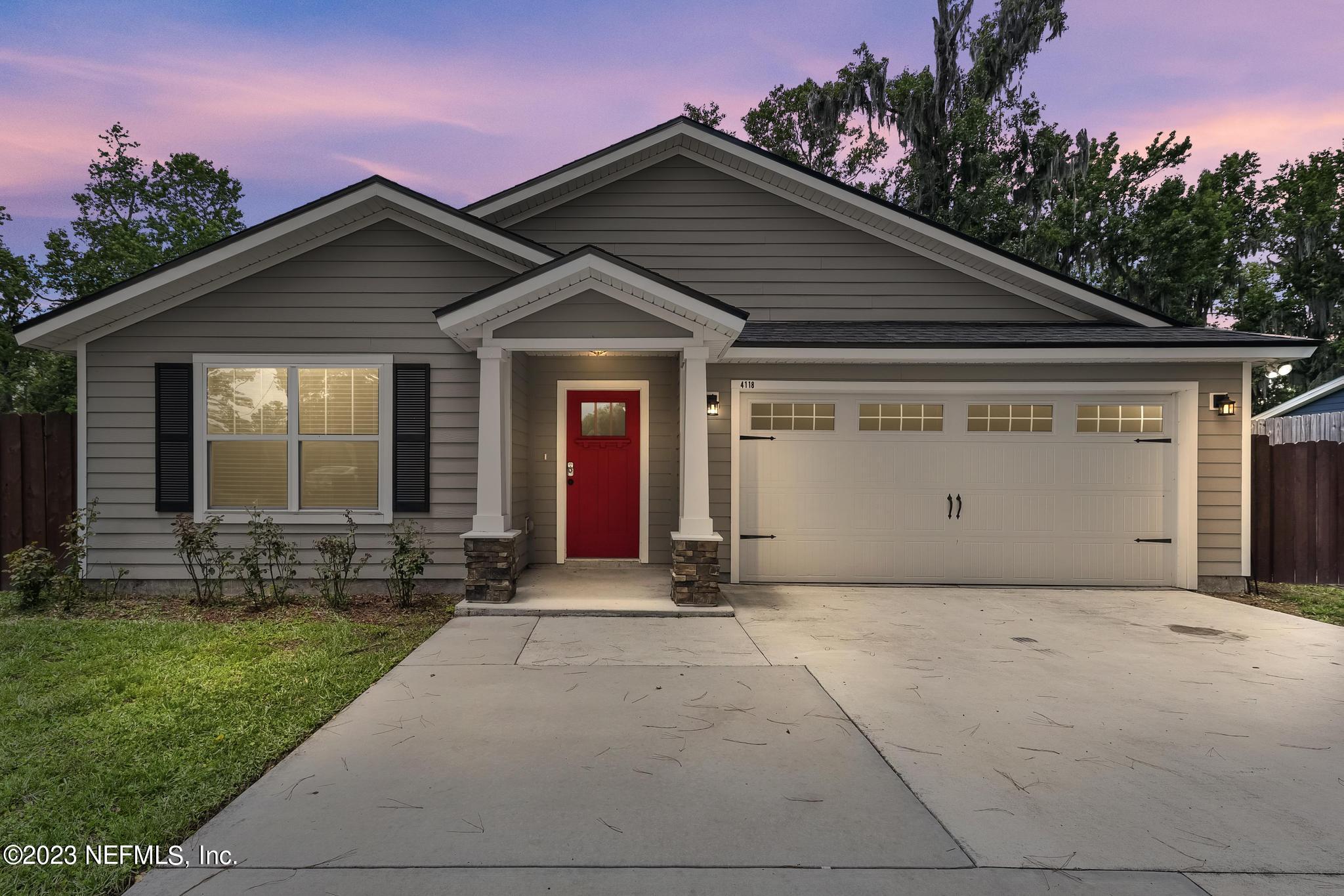 4118 Spring Park Circle Jacksonville, FL 32207 - Photo 1 of 21 a front view of a house with a yard and garage