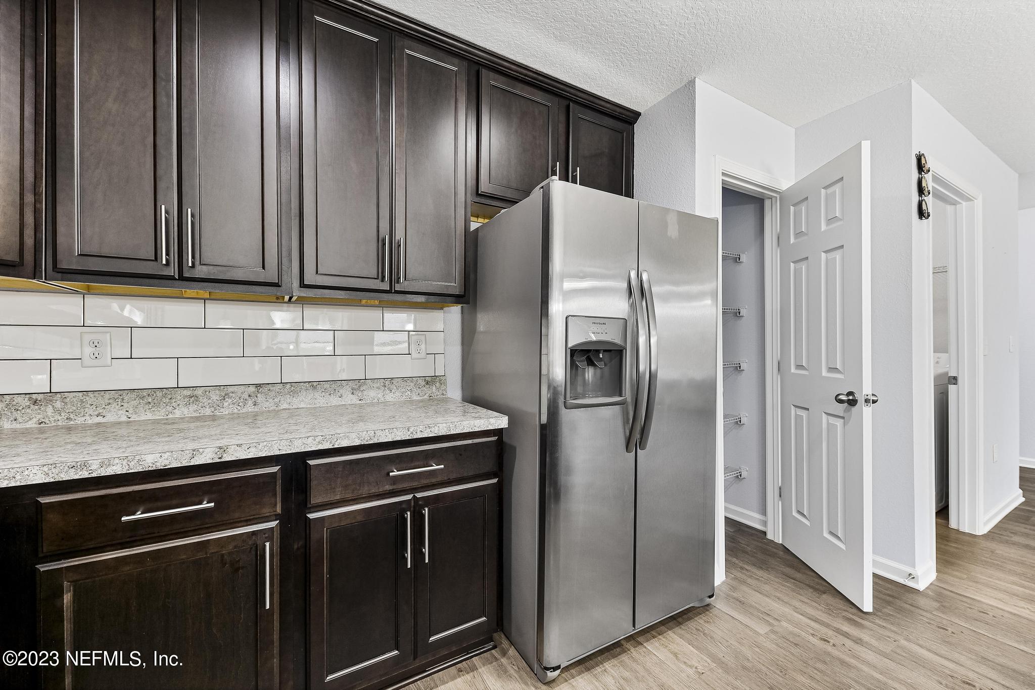 4118 Spring Park Circle Jacksonville, FL 32207 - Photo 11 of 21 a kitchen with stainless steel appliances granite countertop wooden cabinets a refrigerator and a sink