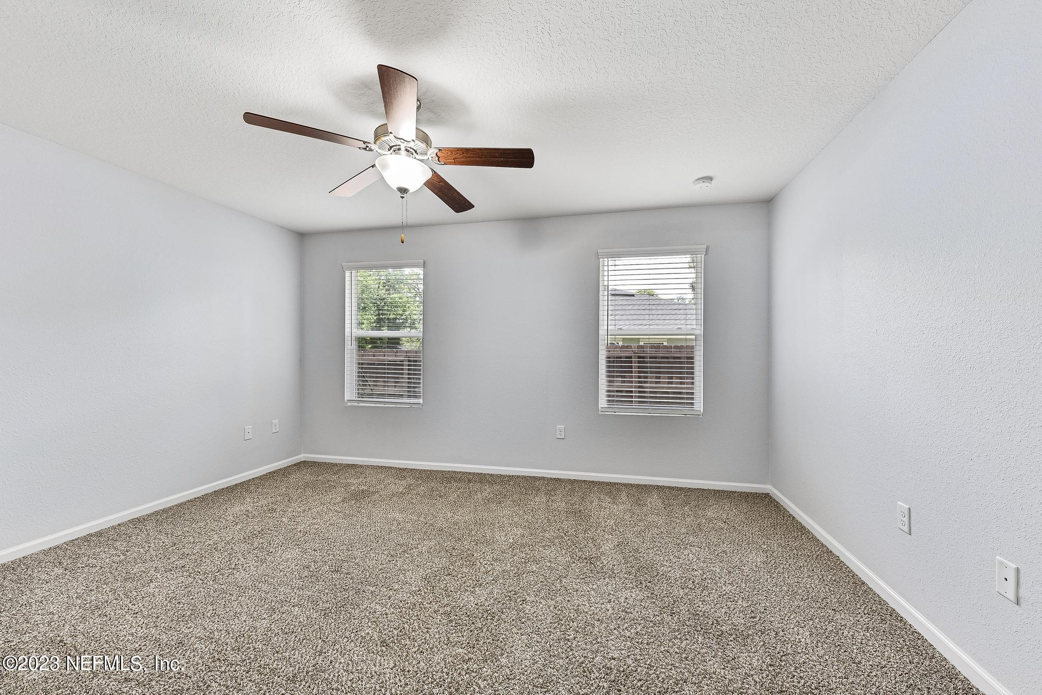 4118 Spring Park Circle Jacksonville, FL 32207 - Photo 13 of 21 wooden floor in an empty room with a window