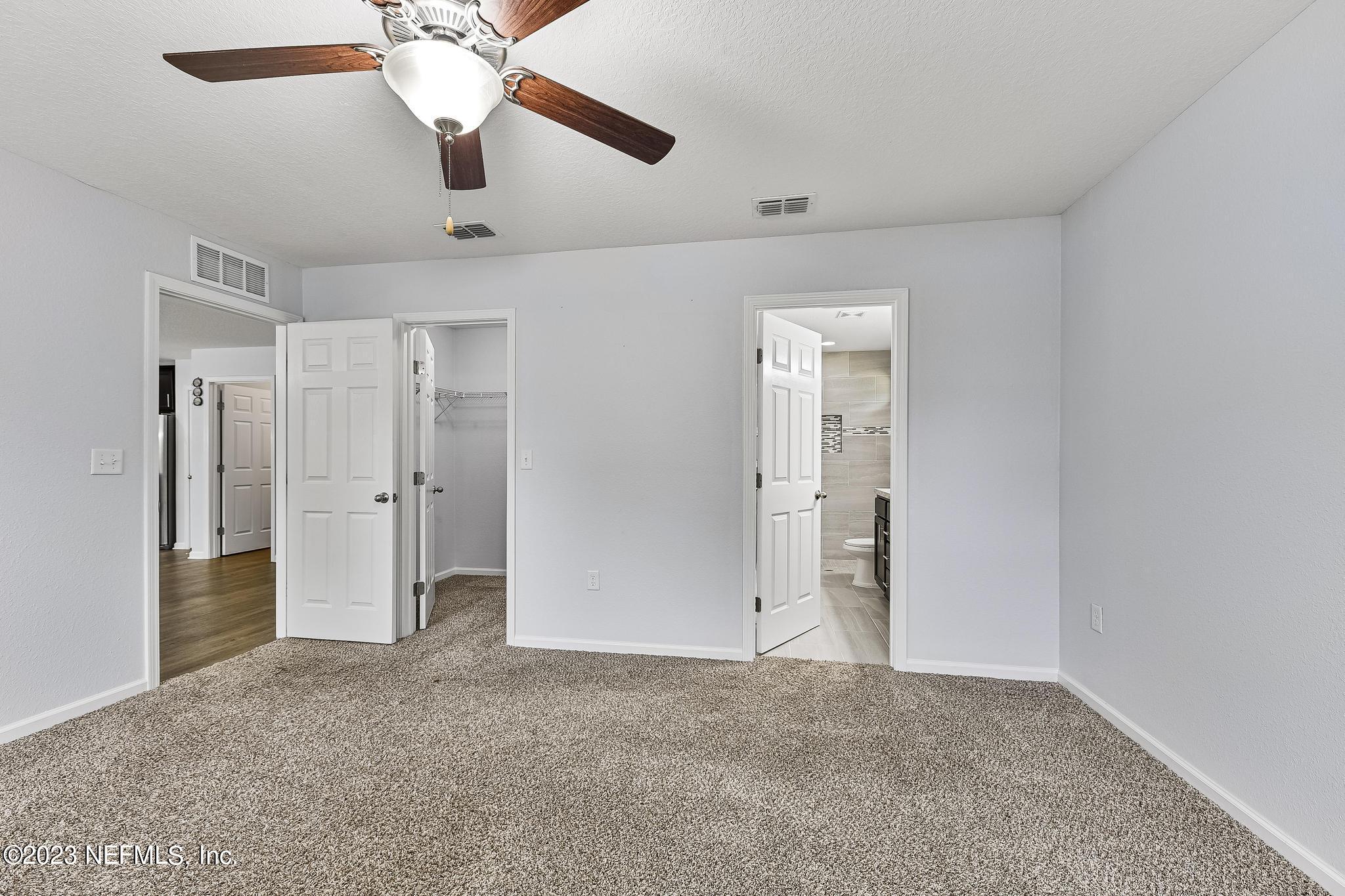 4118 Spring Park Circle Jacksonville, FL 32207 - Photo 14 of 21 a view of an empty room and chandelier fan