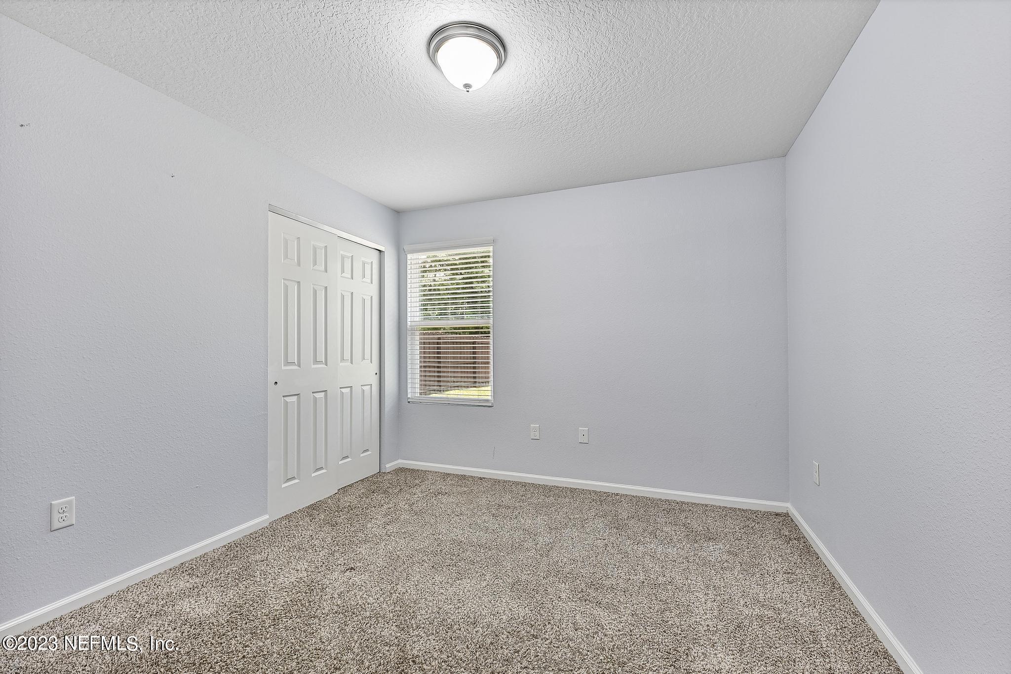 4118 Spring Park Circle Jacksonville, FL 32207 - Photo 16 of 21 an empty room with windows