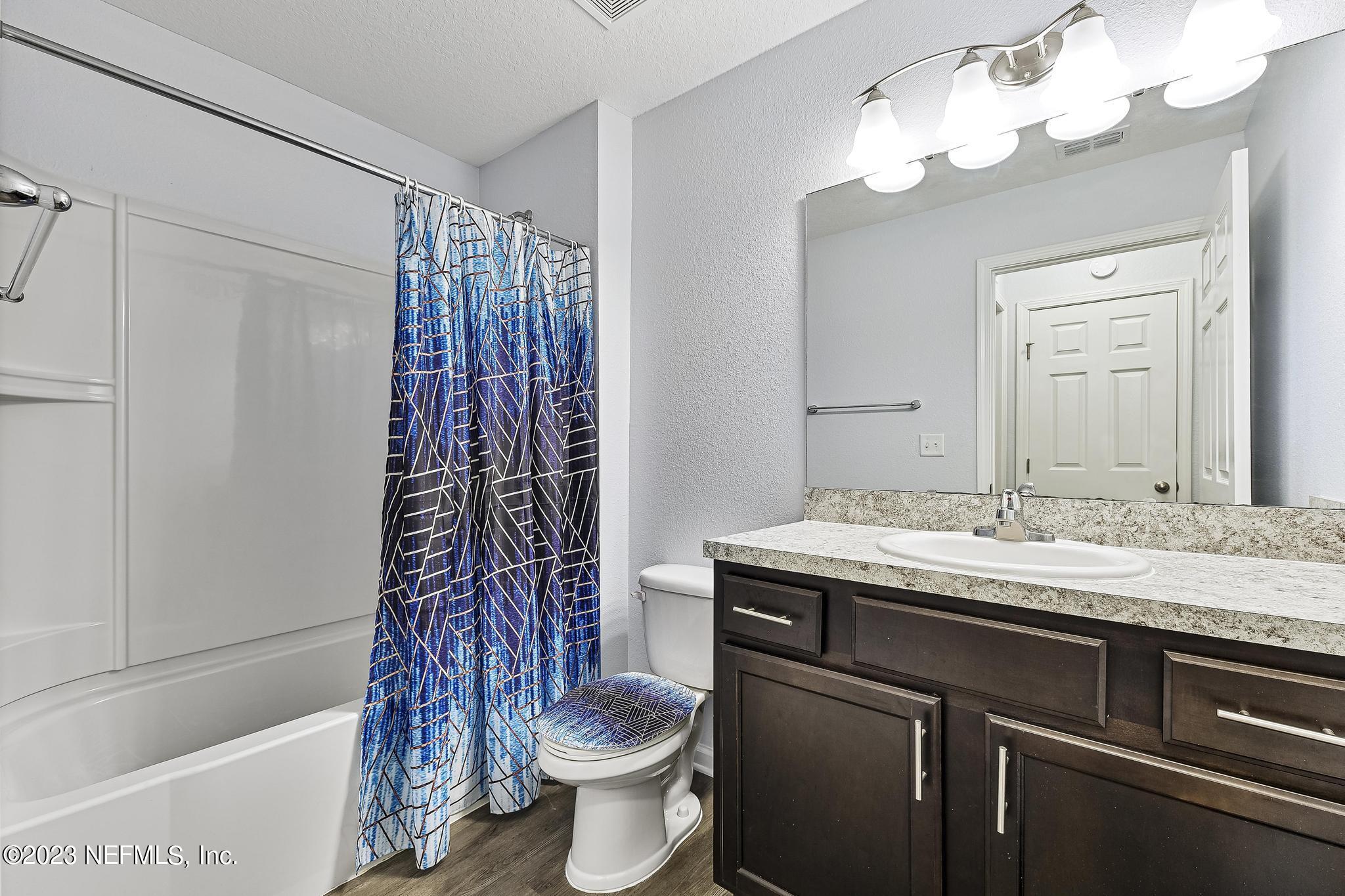 4118 Spring Park Circle Jacksonville, FL 32207 - Photo 17 of 21 a bathroom with a granite countertop sink toilet and shower