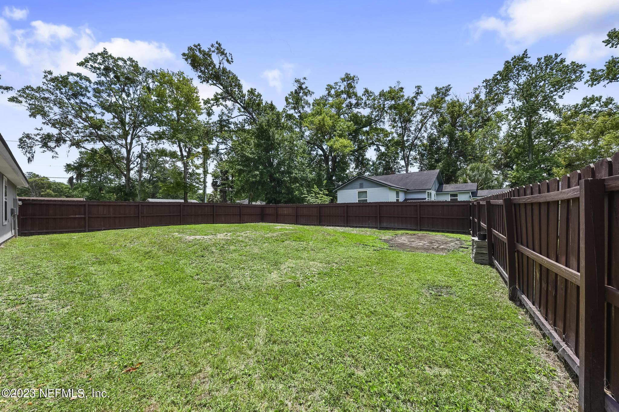 4118 Spring Park Circle Jacksonville, FL 32207 - Photo 20 of 21 a view of yard with green space and trees in the background