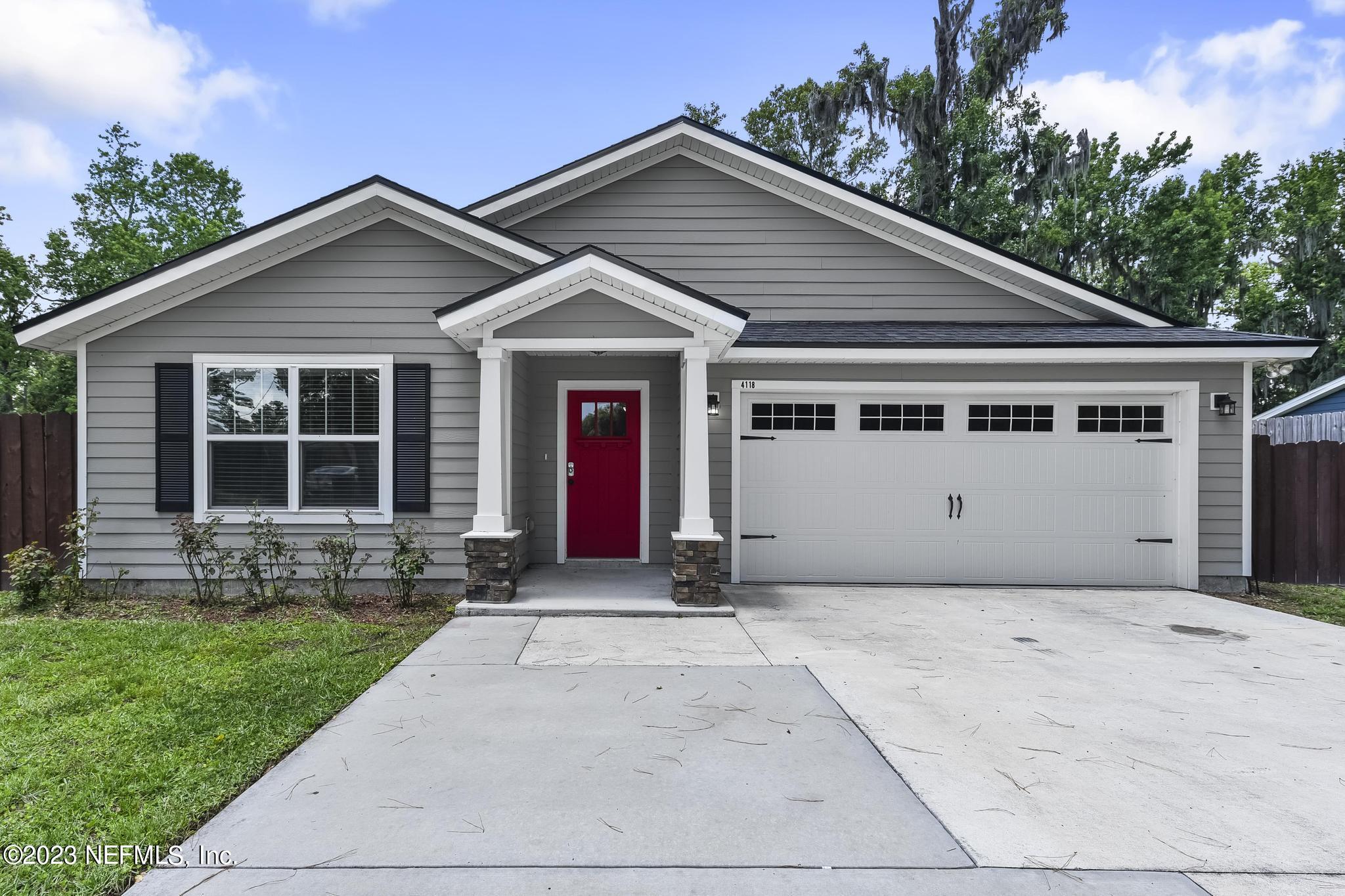 4118 Spring Park Circle Jacksonville, FL 32207 - Photo 2 of 21 a front view of a house with a yard and garage
