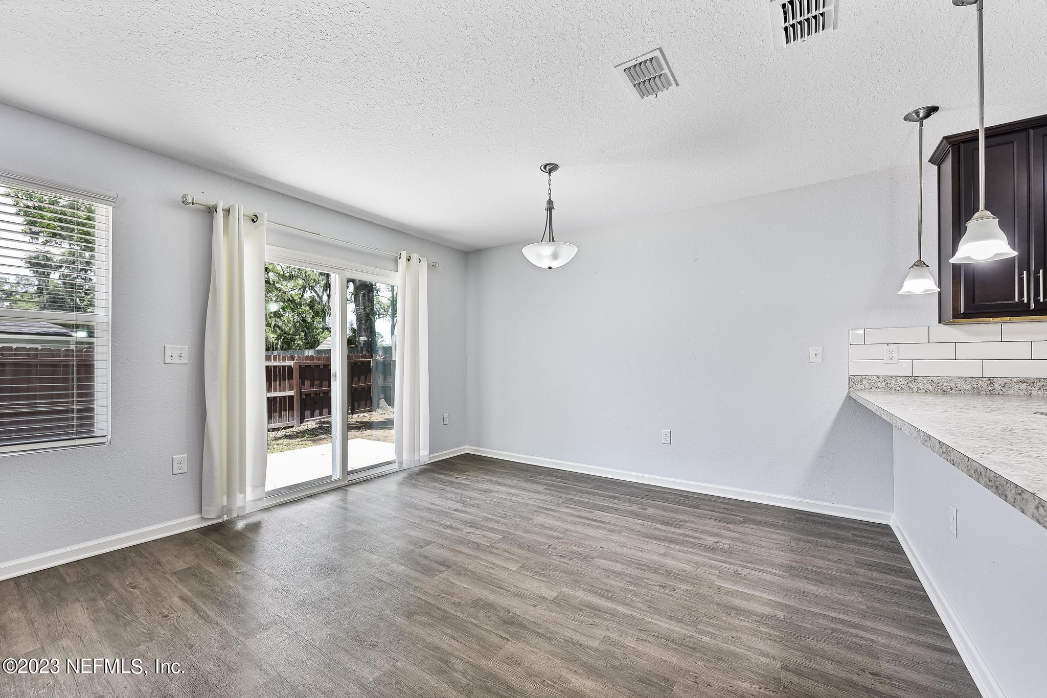 4118 Spring Park Circle Jacksonville, FL 32207 - Photo 7 of 21 a view of an empty room with wooden floor and a window