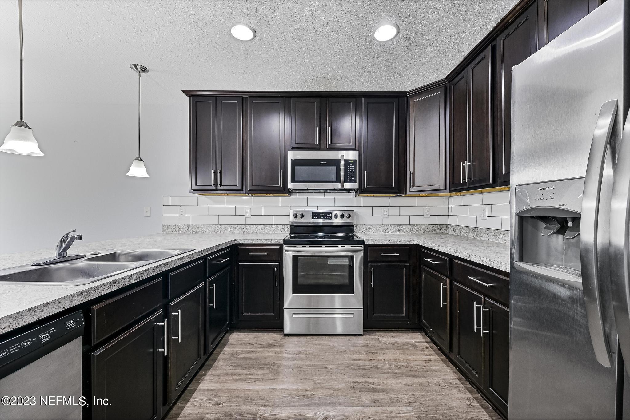 4118 Spring Park Circle Jacksonville, FL 32207 - Photo 9 of 21 a kitchen with a sink stove and refrigerator
