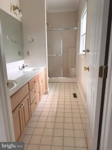 a bathroom with a sink a mirror and shower