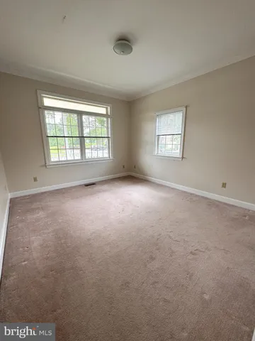 an empty room with a empty space and windows