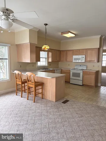 a kitchen with appliances cabinets and furniture