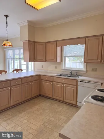 a kitchen with sink cabinets and window