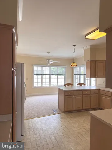 a large kitchen with kitchen island granite countertop a sink and a refrigerator