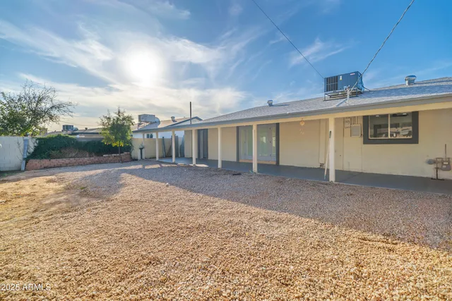 a view of a house with a backyard