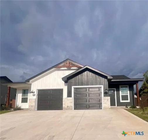 a front view of a house with yard and garage