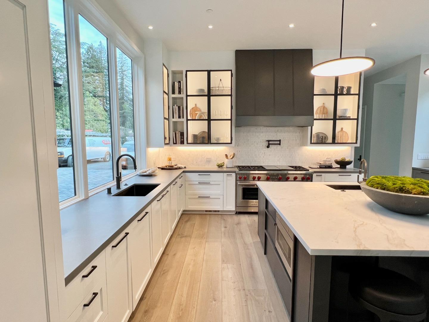 60 Shearer Drive Atherton, CA 94027 - Photo 10 of 39 a large kitchen with kitchen island a large counter space a sink appliances and cabinets
