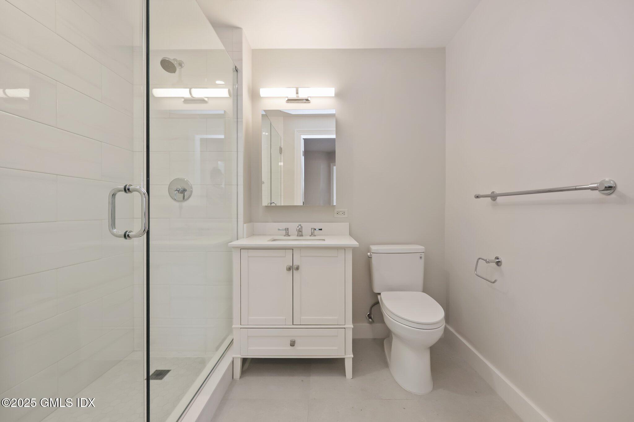 2 East Elm Street, Unit 42 Greenwich, CT 06830 - Photo 12 of 24 a bathroom with a toilet a sink and shower