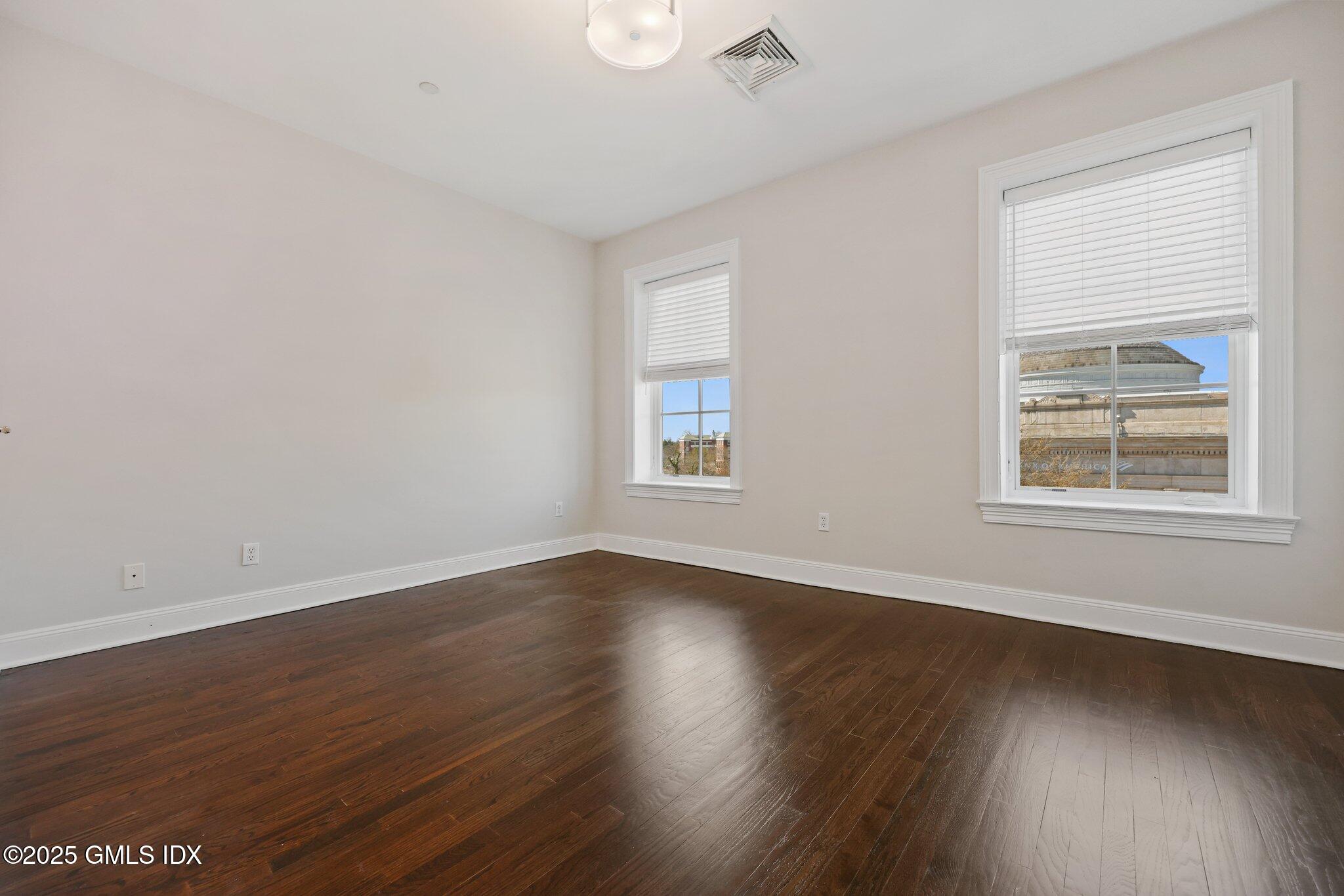 2 East Elm Street, Unit 42 Greenwich, CT 06830 - Photo 13 of 24 a view of an empty room with wooden floor and a window