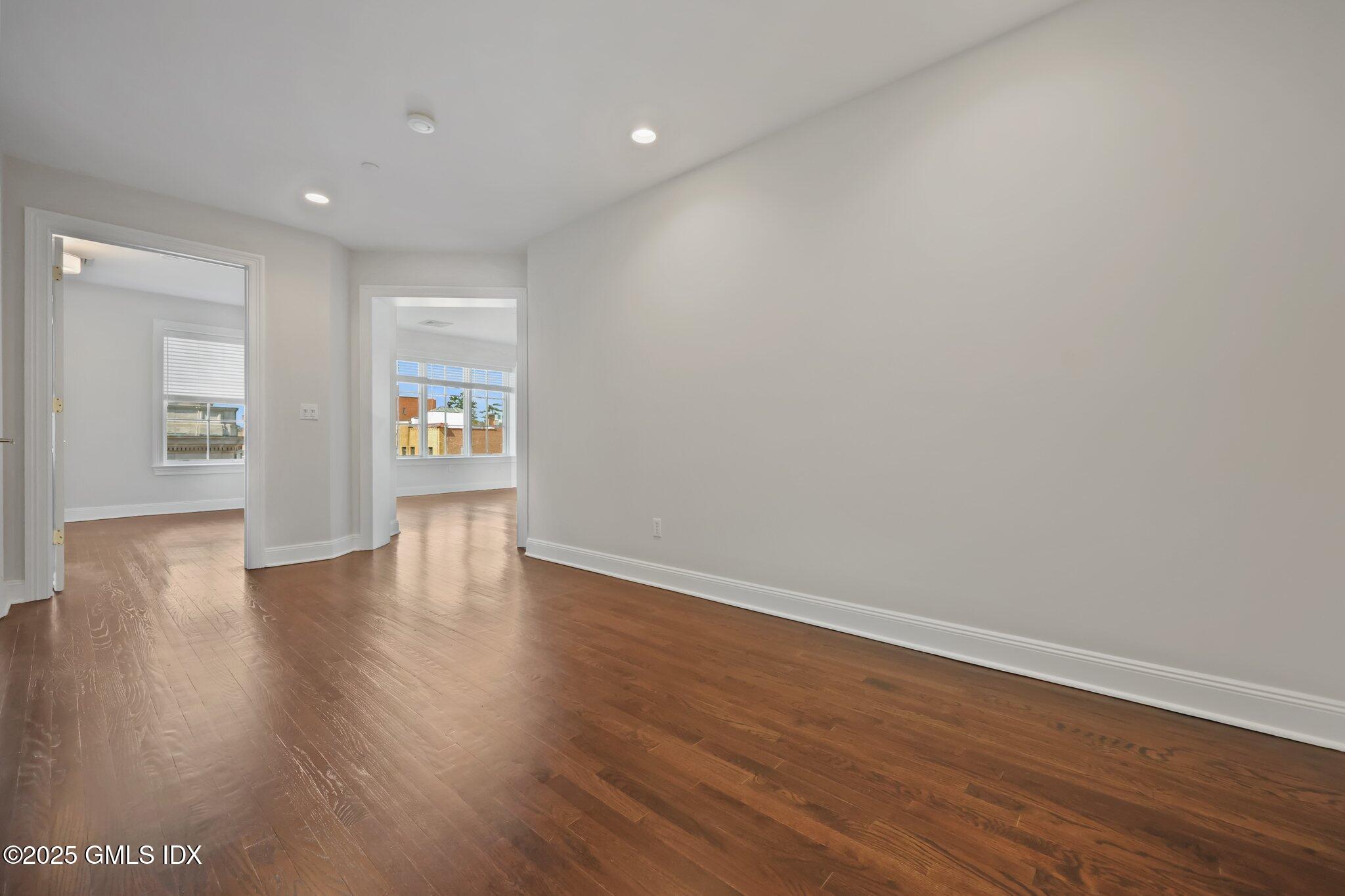 2 East Elm Street, Unit 42 Greenwich, CT 06830 - Photo 8 of 24 a view of an empty room with wooden floor and a window