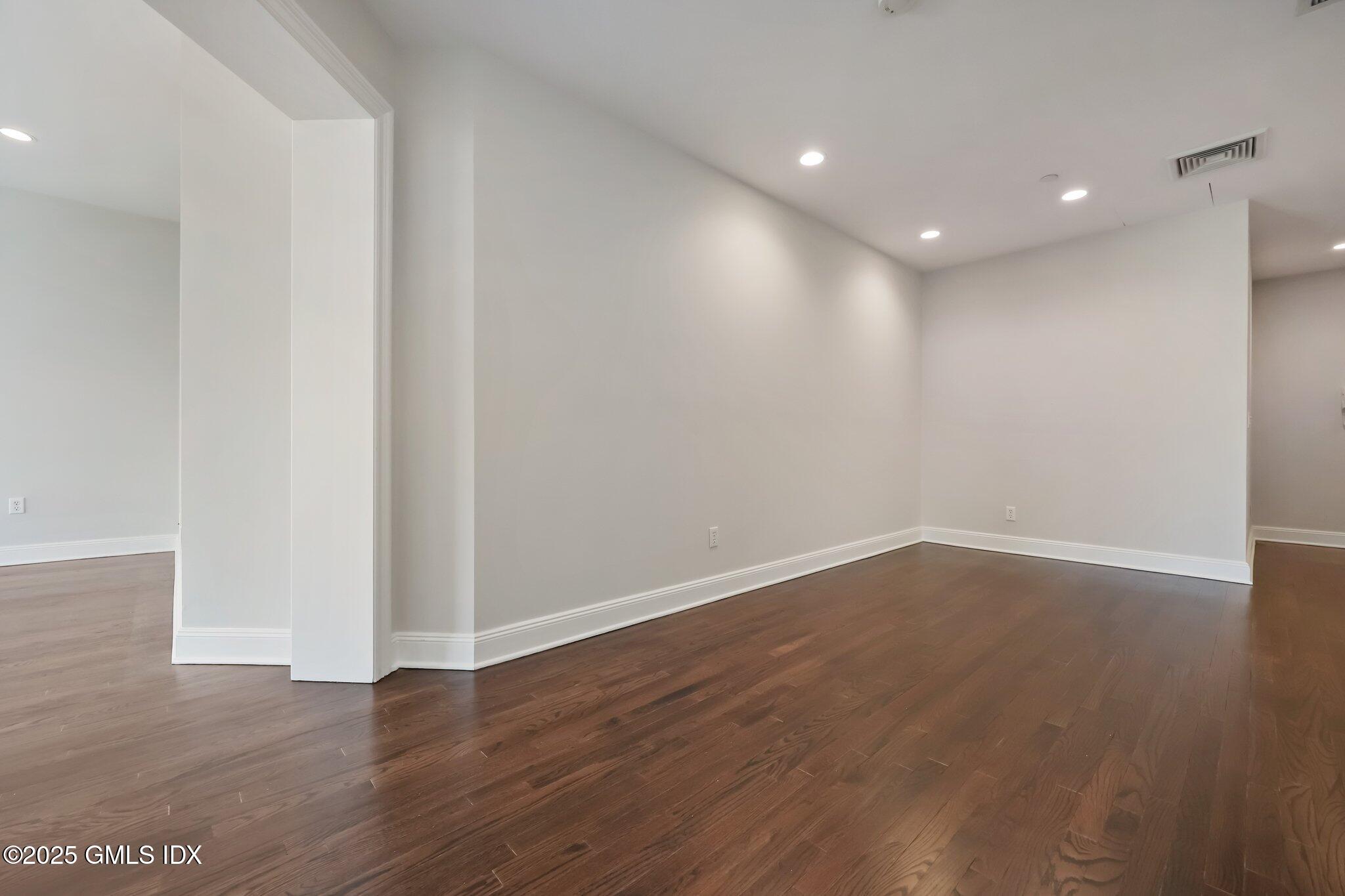 2 East Elm Street, Unit 42 Greenwich, CT 06830 - Photo 10 of 24 a view of an empty room with wooden floor