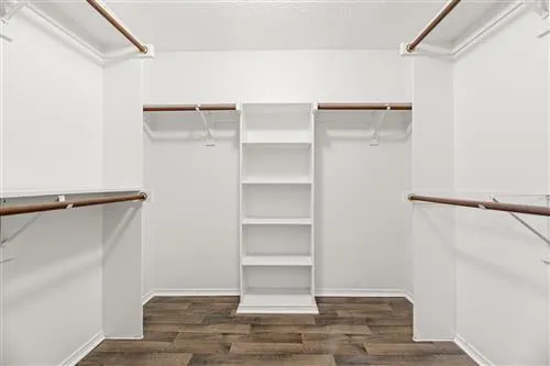 a view of walk in closet with empty racks