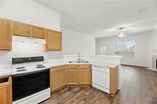 a kitchen with a stove top oven sink and cabinets
