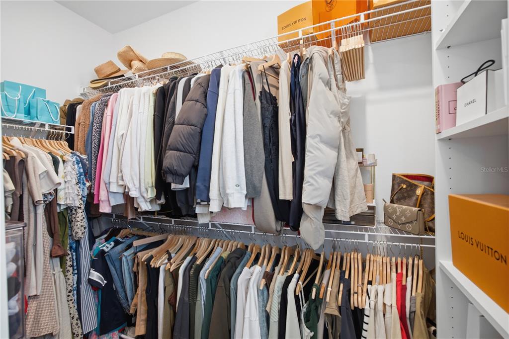 13816 Sharp Hawk Drive Riverview, FL 33569 - Photo 42 of 76 a view of walk in closet with clothes